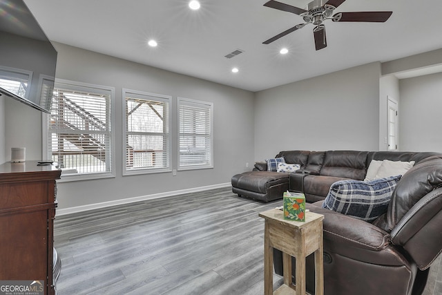 living room featuring ceiling fan and light hardwood / wood-style flooring