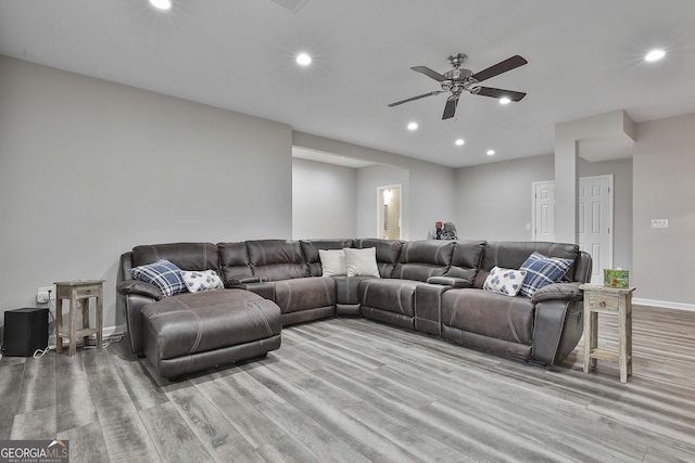 living room featuring ceiling fan and light wood-type flooring