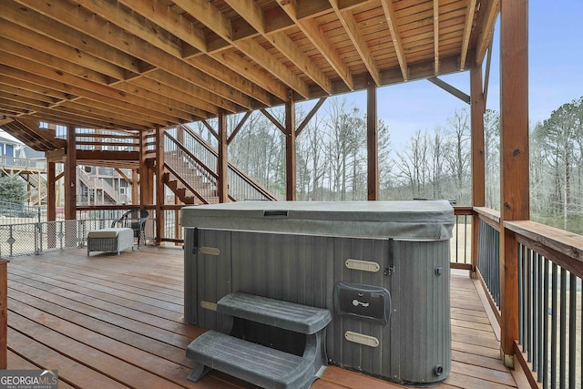 wooden deck with a hot tub