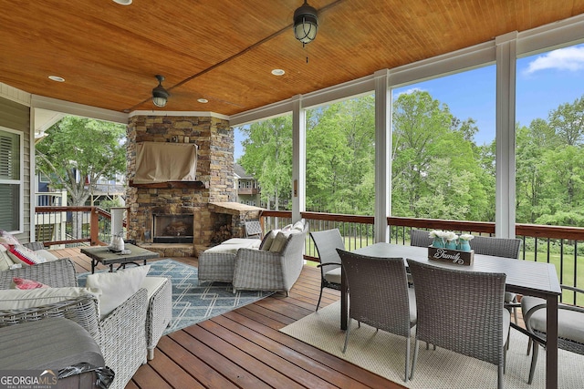 128 Greenview Dr, Newnan, GA 30265 - wooden deck featuring an outdoor living space with a fireplace, a ceiling fan, and outdoor dining area