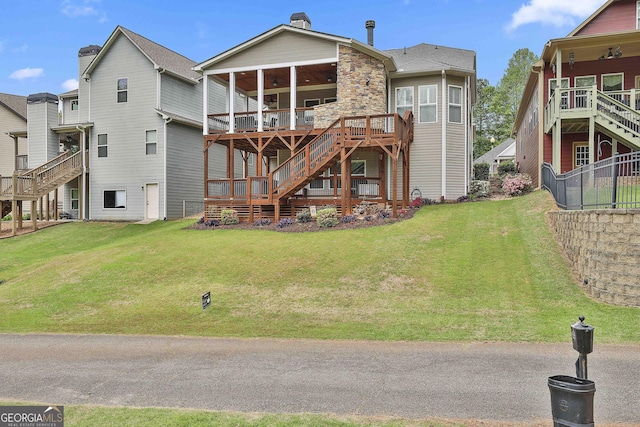 128 Greenview Dr, Newnan, GA 30265 - back of house with a yard, a ceiling fan, stairway, and a deck