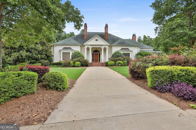 128 Greenview Dr, Newnan, GA 30265 - neoclassical home featuring a chimney and a front yard