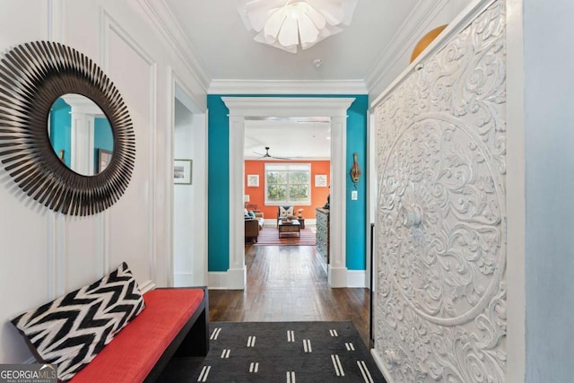 corridor with ornamental molding and dark wood-type flooring