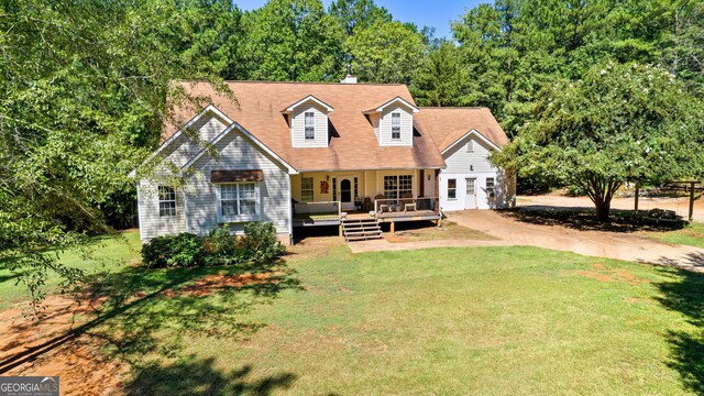 cape cod home featuring covered porch and a front lawn