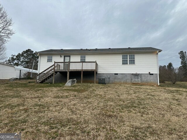 view of front of property with a wooden deck and a front lawn