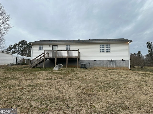 back of property with a wooden deck, a yard, and central AC unit