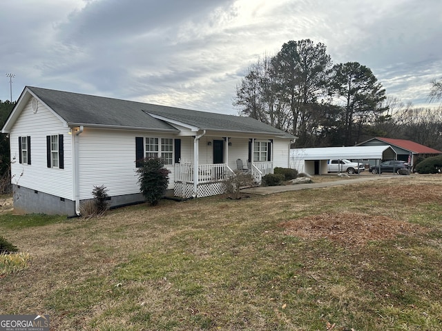 view of front of home with a front yard, a carport, and a porch