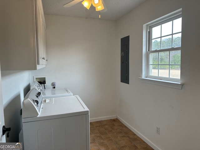 clothes washing area with separate washer and dryer, cabinets, electric panel, ceiling fan, and a textured ceiling