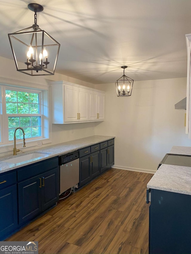 kitchen with stainless steel dishwasher, sink, hanging light fixtures, and white cabinets