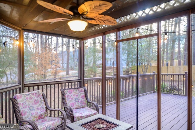 unfurnished sunroom with ceiling fan