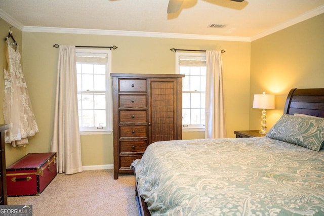 bedroom with crown molding, ceiling fan, and light carpet