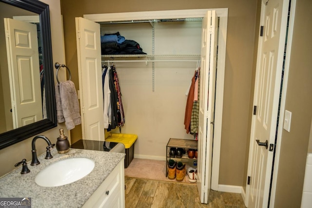 bathroom with vanity and hardwood / wood-style floors