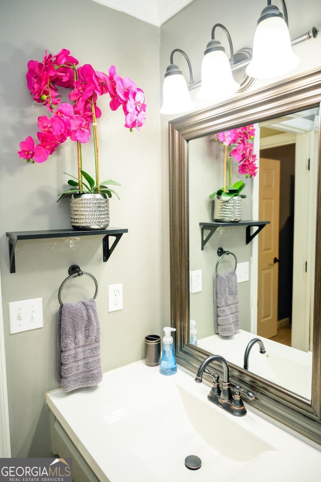 bathroom with vanity and crown molding