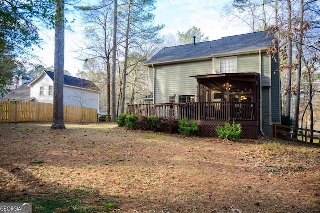 back of house featuring a wooden deck