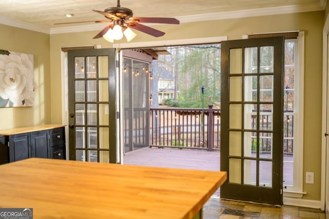 doorway with crown molding, ceiling fan, and french doors