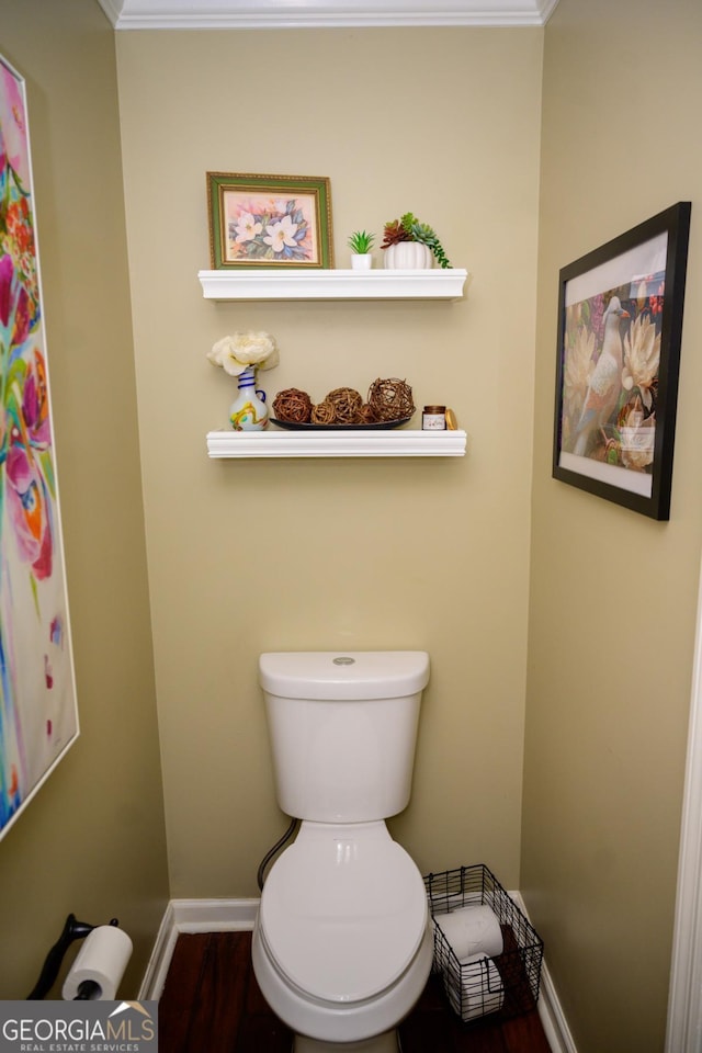 bathroom featuring hardwood / wood-style flooring, ornamental molding, and toilet