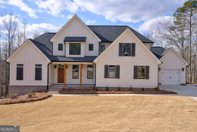 modern inspired farmhouse with a garage and covered porch