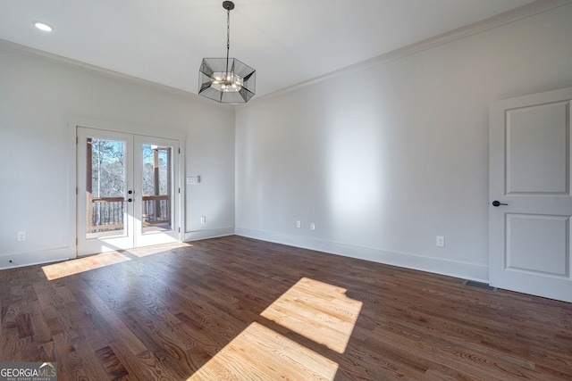 unfurnished room featuring ornamental molding, dark wood-type flooring, and french doors