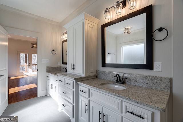 bathroom with french doors and vanity