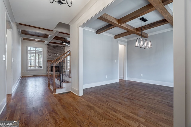 unfurnished living room featuring coffered ceiling, beam ceiling, and dark hardwood / wood-style floors