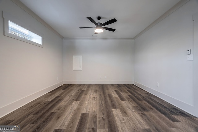 empty room featuring crown molding, dark hardwood / wood-style floors, and ceiling fan