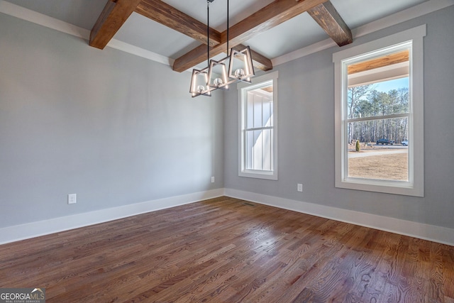 empty room featuring coffered ceiling, a notable chandelier, wood-type flooring, and beamed ceiling