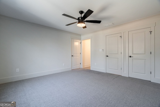 unfurnished bedroom with ceiling fan and carpet flooring