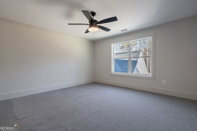 carpeted spare room with crown molding and ceiling fan