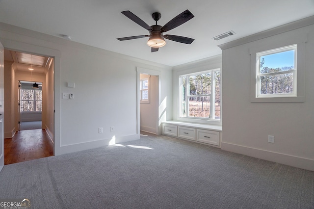 unfurnished bedroom featuring ornamental molding, carpet floors, and ceiling fan