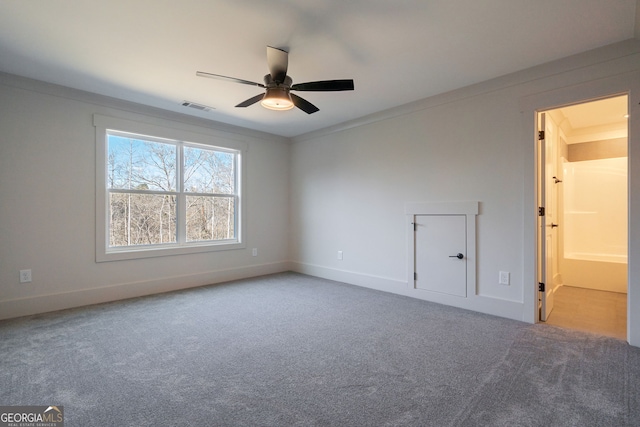 carpeted empty room featuring ceiling fan and ornamental molding