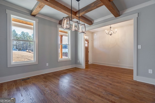 unfurnished dining area featuring dark hardwood / wood-style flooring, beam ceiling, coffered ceiling, and a chandelier