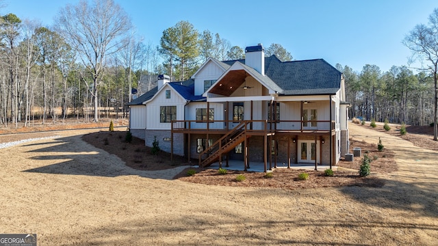 rear view of house featuring a wooden deck, a patio, ceiling fan, and french doors