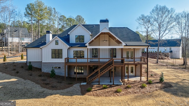 back of house featuring a deck and a patio