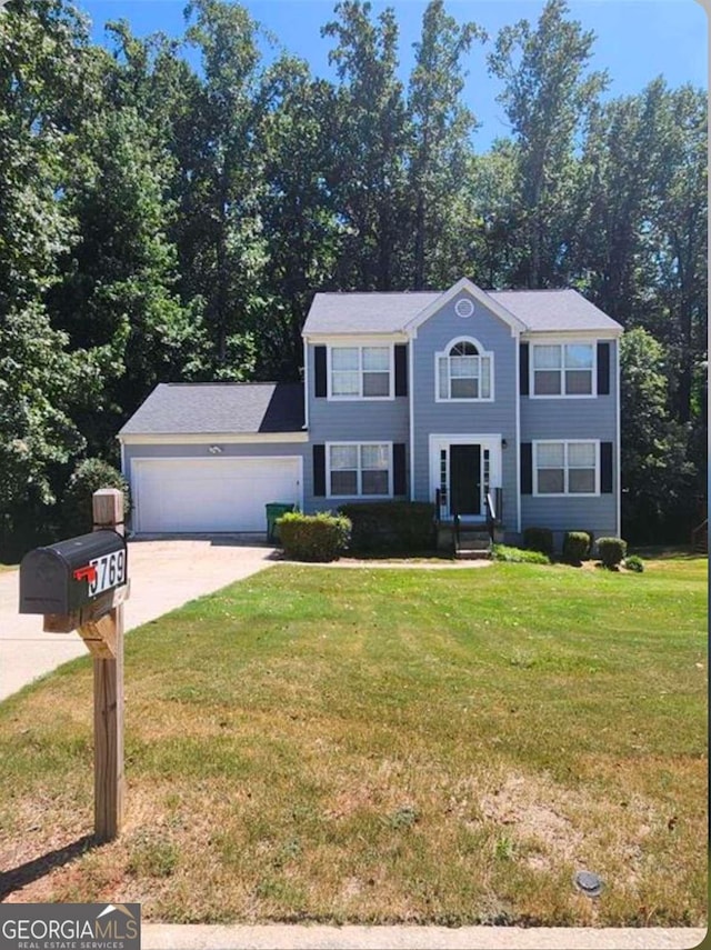 colonial-style house with a garage and a front lawn