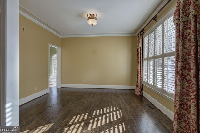 unfurnished room featuring crown molding and dark wood-type flooring