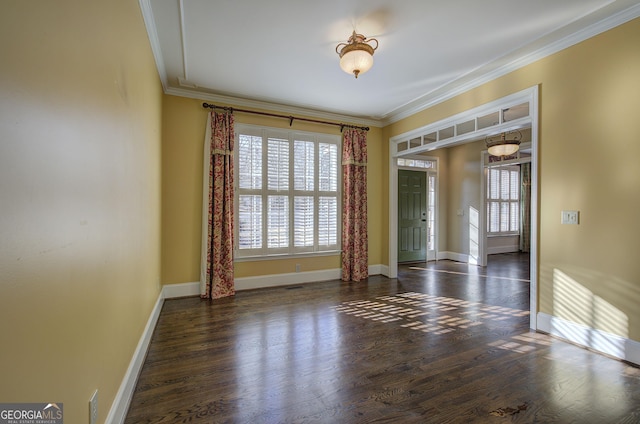 unfurnished room featuring dark wood-type flooring and ornamental molding