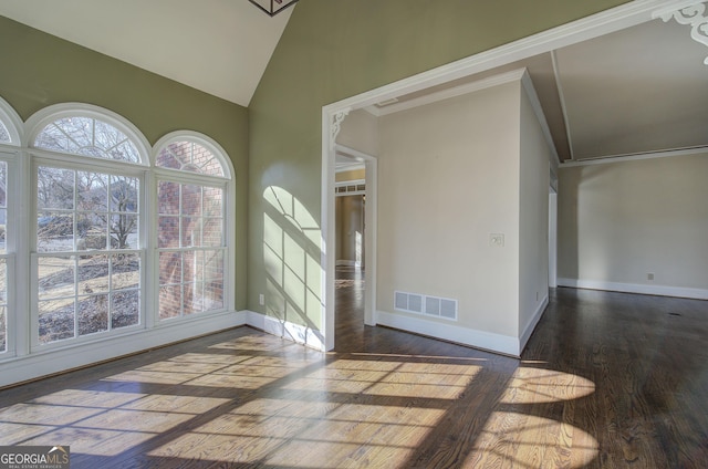 interior space with crown molding, vaulted ceiling, dark hardwood / wood-style floors, and plenty of natural light