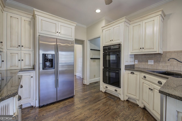 kitchen with sink, dark hardwood / wood-style flooring, decorative backsplash, black appliances, and crown molding