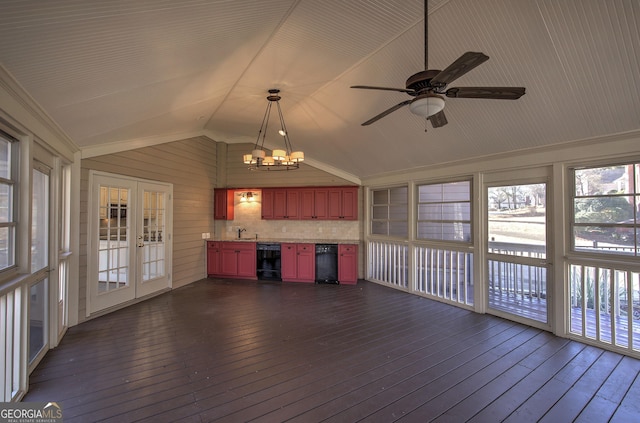 unfurnished sunroom with vaulted ceiling, sink, beverage cooler, and french doors