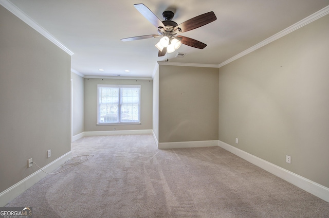 carpeted spare room with crown molding and ceiling fan