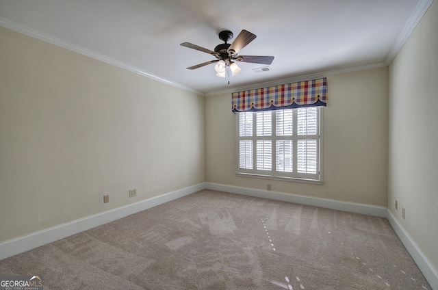 empty room featuring crown molding, light carpet, and ceiling fan