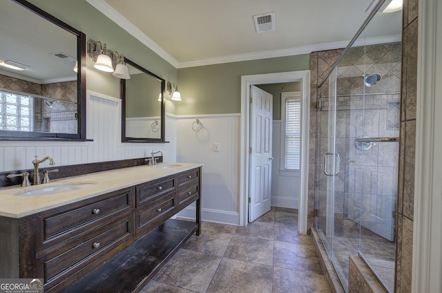 bathroom with vanity, an enclosed shower, and crown molding