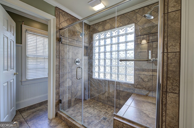 bathroom with ornamental molding, a wealth of natural light, and an enclosed shower