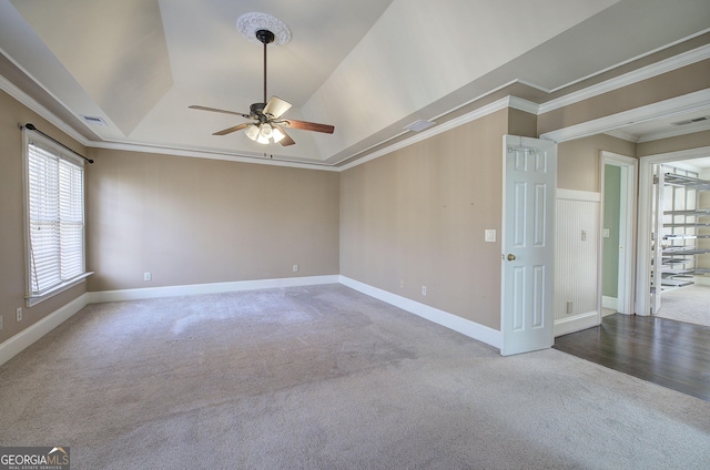 unfurnished room with ornamental molding, carpet, ceiling fan, and a tray ceiling