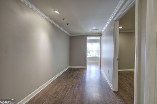 spare room featuring ornamental molding and dark hardwood / wood-style floors