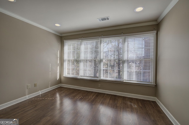 unfurnished room featuring dark wood-type flooring and ornamental molding