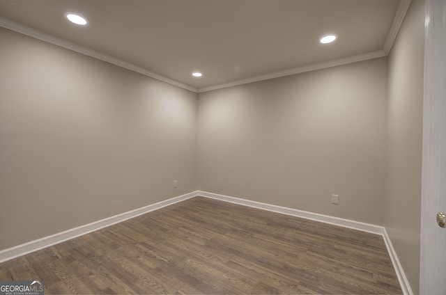 empty room with crown molding and dark wood-type flooring