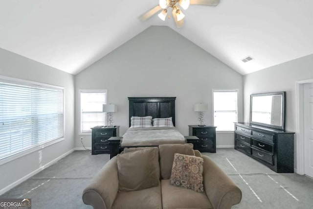 carpeted bedroom with ceiling fan, vaulted ceiling, and multiple windows