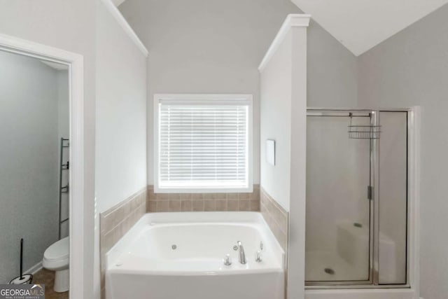 bathroom featuring vaulted ceiling, shower with separate bathtub, and toilet