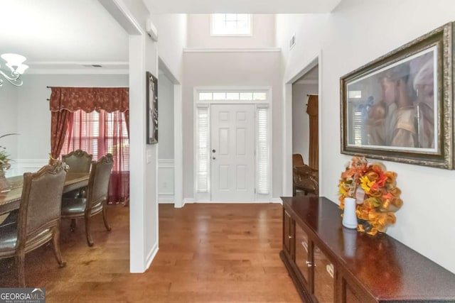 entryway with an inviting chandelier and hardwood / wood-style floors